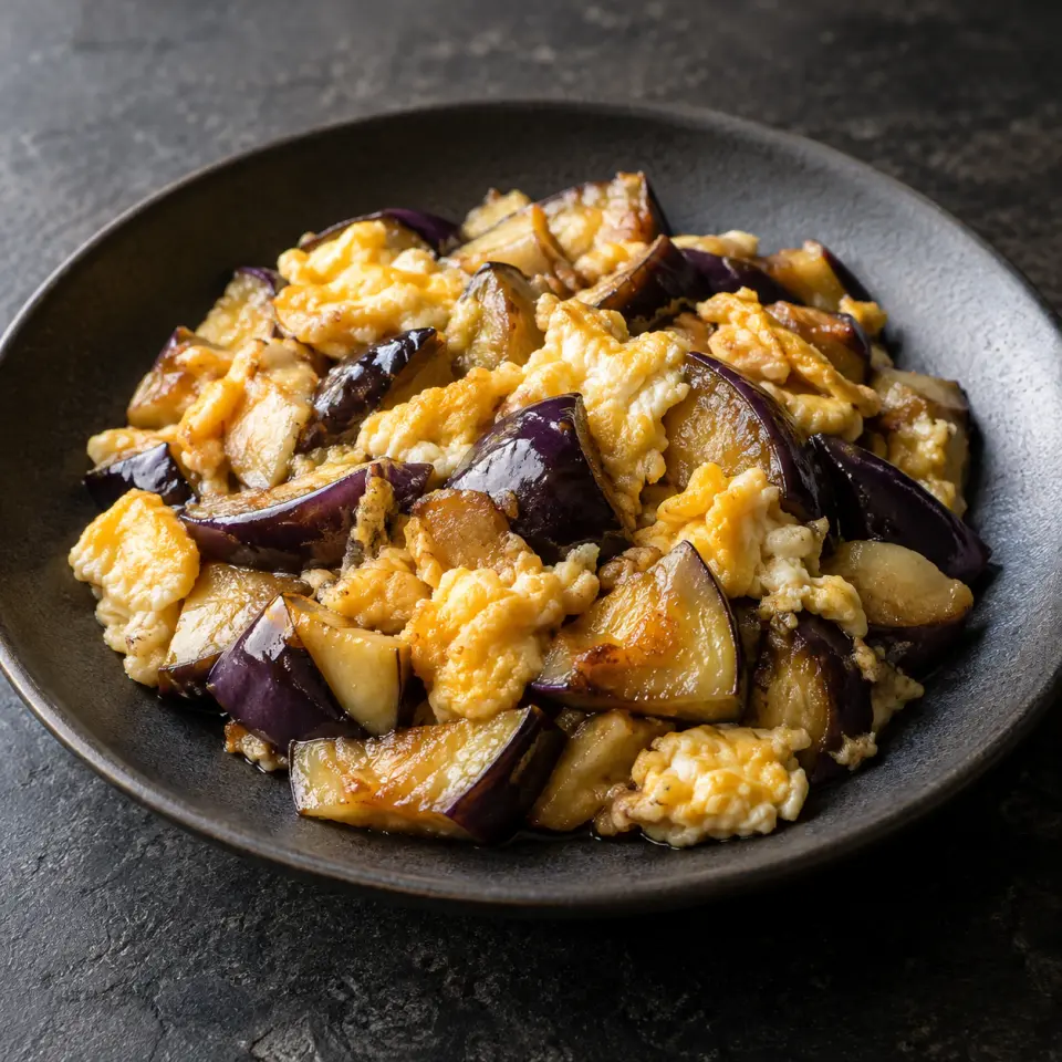 Eggplant Egg on a plate on a dark stone table, made with eggplant, egg.